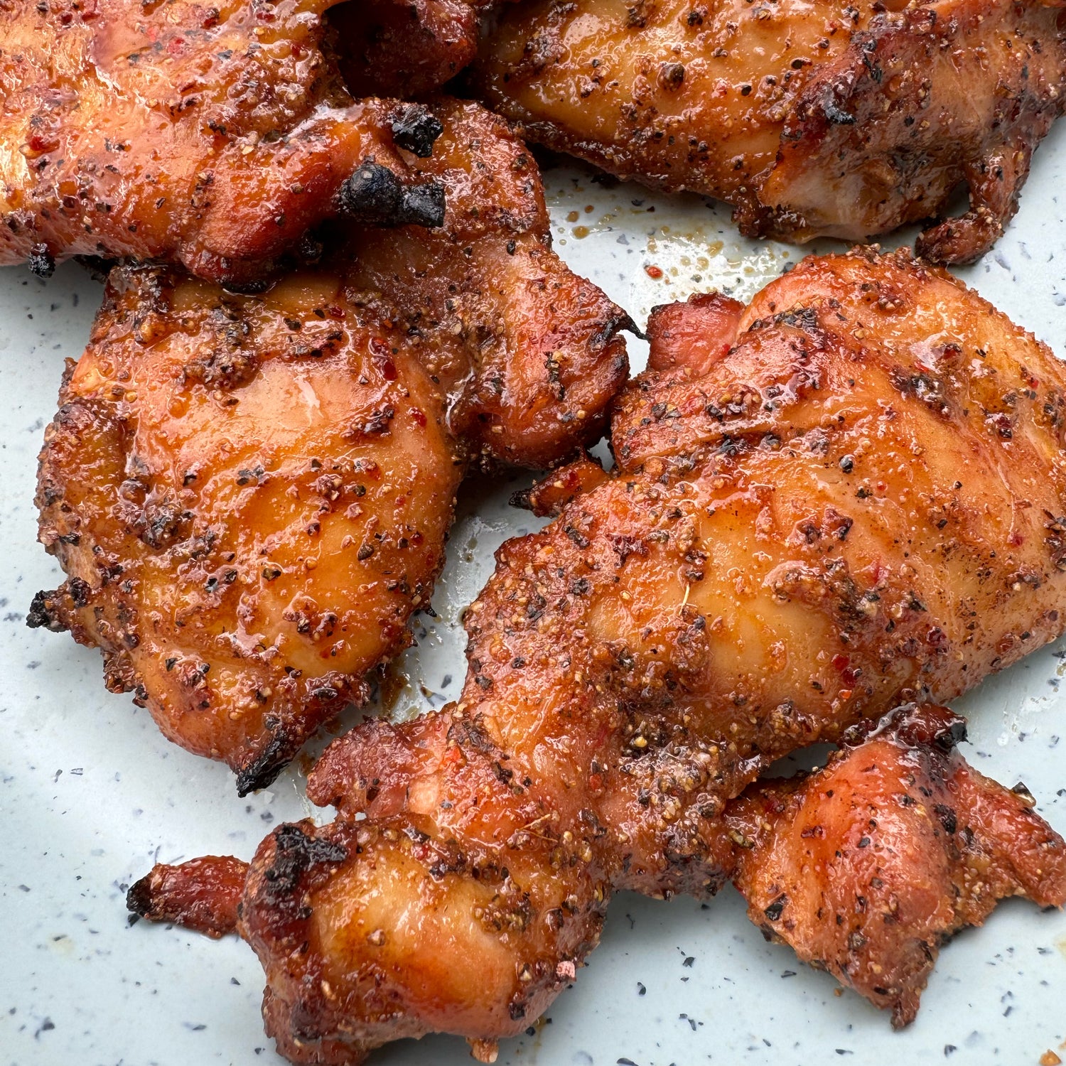 Grilled chicken thighs marinated in honey sriracha mix