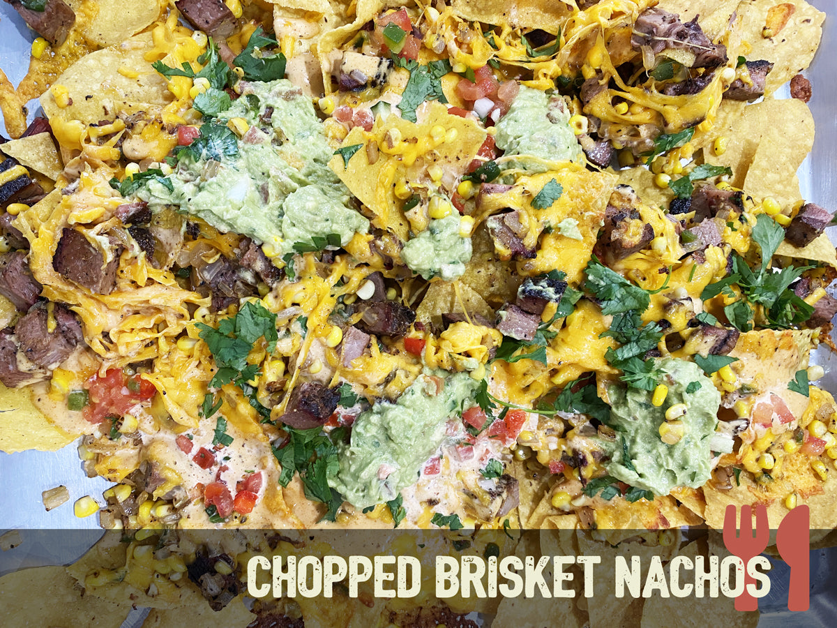 Top view of chopped brisket nachos with guacamole