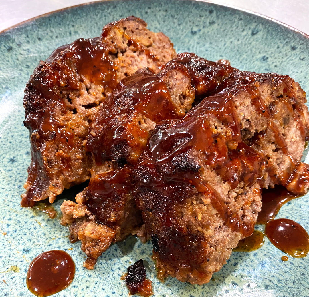 Plate of Spellbound Meatloaf drizzled with Sweet BBQ Sauce